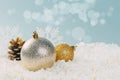 Beautiful golden Christmas balls in the snow on a blue background with bokeh lights. happy new year card Royalty Free Stock Photo