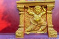 Beautiful golden demon carving in act of carrying the building on the public Buddhist church wall at Wat Srisupan temple in Chiang Royalty Free Stock Photo