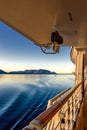 Beautiful golden early morning light of dawn and ocean water ripples from ship`s wake, Inside Passage, Alaska, USA.