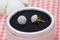 Beautiful golden earrings decorated with diamond display in jewelry box