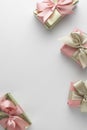 Beautiful golden gifts with pink bows ribbon on white. Christmas, party, birthday background. Celebrate shinny surprise boxes copy