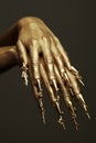 Beautiful golden hands with golden long arty nails. Close up. Studio shot Royalty Free Stock Photo