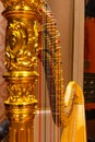 Beautiful golden harp strings close up. Musical instruments of the Orchestra in philharmonia Royalty Free Stock Photo