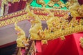 Beautiful golden naga sculptures on the church gable roof at the public Buddhist temple in Thailand. Royalty Free Stock Photo