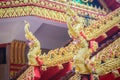 Beautiful golden naga sculptures on the church gable roof at the public Buddhist temple in Thailand. Royalty Free Stock Photo