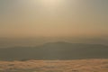 Beautiful golden natural sunlight and twiligh of sunrise shining to in the mist on valley of mountain in Thailand