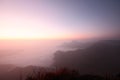 Beautiful golden natural sunlight and twiligh of sunrise shining to in the mist on valley of mountain in Thailand