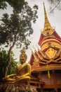 Beautiful golden pagoda with decorative Thai style fine art at public Buddhist Wat Phu Phlan Sung temple, Nachaluay, Ubon Ratchath Royalty Free Stock Photo
