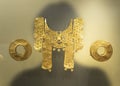 Beautiful golden pieces of a cacique representating a jaguar with nose ring and ear expansions Royalty Free Stock Photo