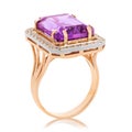 Beautiful golden ring with a large amethyst isolated