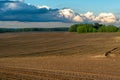 Beautiful golden rows of soil before planting at sunset. Furrowing on a plowed field prepared for spring sowing of agricultural Royalty Free Stock Photo