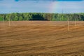 Beautiful golden rows of soil before planting at sunset. Furrowing on a plowed field prepared for spring sowing of agricultural Royalty Free Stock Photo