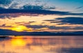 Beautiful golden sky in the morning with sunrise over mountain range and lake or river. Landscape of reservoir and mountain. Peace Royalty Free Stock Photo