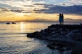 A beautiful golden sunset on the lake Garda, Italy. Silhouette of two girls