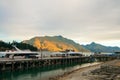 Beautiful golden sunset lights on mountains, luxury boats docking on lake Wakatipu, Queenstown Wharf Royalty Free Stock Photo