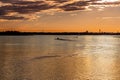 Beautiful golden sunset over lake Vanern in Sweden with city and sky horizon. Ships and small boats. Royalty Free Stock Photo