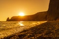 Beautiful golden sunset over the sea, the sun sets behind the mountain. Jasper Beach, Cape Fiolent, no bodies. Royalty Free Stock Photo