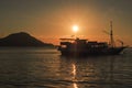 Beautiful golden sunset with a sailboat. Beautiful Sunset in tropical Komodo island, Labuan Bajo, Fores, Indonesia Royalty Free Stock Photo