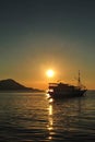 Beautiful golden sunset with a sailboat. Beautiful Sunset in tropical Komodo island, Labuan Bajo, Fores, Indonesia Royalty Free Stock Photo