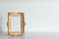 Beautiful golden vintage frame on white wooden table, space for text Royalty Free Stock Photo