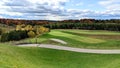 Beautiful golf course scenery on a cloudy autumn day, with fall foliage. Royalty Free Stock Photo