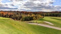 Beautiful golf course scenery on a cloudy autumn day, with fall foliage. Royalty Free Stock Photo