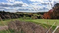 Beautiful golf course scenery on a cloudy autumn day, with fall foliage. Royalty Free Stock Photo