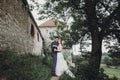 Beautiful gorgeous bride and groom kissing. happy wedding couple hugging and embracing at old castle. happy romantic moments.
