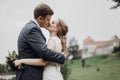 Beautiful gorgeous bride and groom kissing. happy wedding couple hugging and embracing at old castle. happy romantic moments.