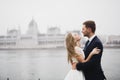 Beautiful gorgeous bride posing to groom and having fun, near Budapest parliament, space for text, wedding couple Royalty Free Stock Photo