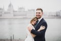 Beautiful gorgeous bride posing to groom and having fun, near Budapest parliament, space for text, wedding couple Royalty Free Stock Photo