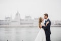 Beautiful gorgeous bride posing to groom and having fun, near Budapest parliament, space for text, wedding couple Royalty Free Stock Photo