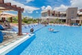 Beautiful gorgeous inviting view of resort outdoor swimming pool with people relaxing in background