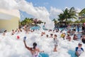 Beautiful, gorgeous view of happy smiling joyful people relaxing and enjoying their time in swimming pool foam party