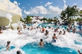 beautiful, gorgeous view of happy smiling joyful people relaxing and enjoying their time in swimming pool foam party on sunny day Royalty Free Stock Photo