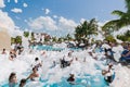 Beautiful, gorgeous view of happy smiling joyful people relaxing and enjoying their time in swimming pool foam party on sunny day Royalty Free Stock Photo