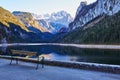 Beautiful Gosausee lake landscape with a bench, forest, clouds and reflections in the water in Austrian Alps. Royalty Free Stock Photo