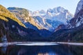 Beautiful Gosausee lake landscape with Dachstein mountains, forest, clouds and reflections in the water in Austrian Alps. Royalty Free Stock Photo