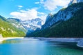 Beautiful Gosausee lake landscape with Dachstein mountains, forest, clouds and reflections in the water in Austrian Alps Royalty Free Stock Photo