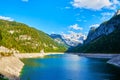 Beautiful Gosausee lake landscape with Dachstein mountains, forest, clouds and reflections in the water in Austrian Alps Royalty Free Stock Photo