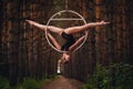 Beautiful and graceful aerial gymnast performs exercises on the air ring Royalty Free Stock Photo