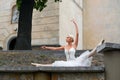 Beautiful graceful ballerina dancing on the streets of an old ci