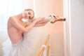 Beautiful graceful ballerina is practicing in the hall against the background of a window. Slender woman in tutu and