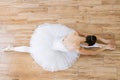 Caucasian ballerina in pointe shoes at white wooden floor background. Royalty Free Stock Photo