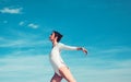 Beautiful and graceful. Cute ballet dancer. Young ballerina dancing on blue sky. Pretty girl in dance wear. Practicing Royalty Free Stock Photo