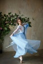 Beautiful graceful girl ballerina in blue dress dancing in point Royalty Free Stock Photo