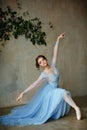 Beautiful graceful girl ballerina in blue dress dancing in point Royalty Free Stock Photo