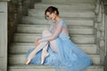 Beautiful graceful girl ballerina in a blue dress and pointe is