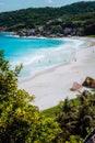 Beautiful Grand Anse beach with unrecognizable tourist people on La Digue island in Seychelles. Vertical shot Royalty Free Stock Photo