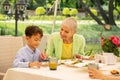 Loving beautiful grandmother giving some food for her boy Royalty Free Stock Photo